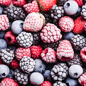 Close up image of frozen strawberries, blueberries, blackberries, and raspberries.